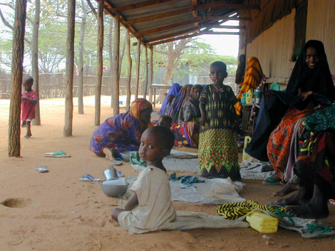 Somali mothers sit outside a feeding center with their malnourished children, Thursday, Sept. 28, 2000 in Dadaab refugee camp in northern Kenya. In 2000 Dadaab was home to 127,000 refugees, mainly Somalis; today that number is 245,000. Photo credit: Andrew England/AP